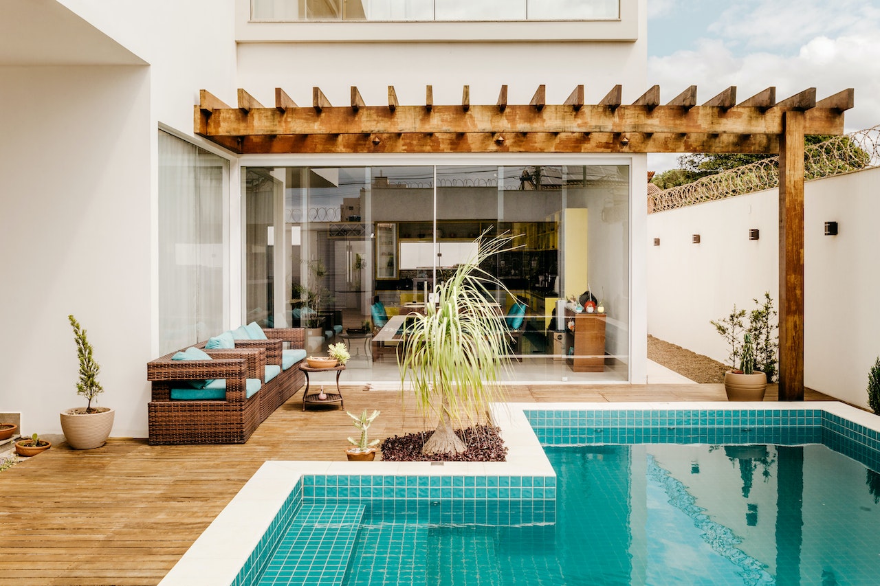 An outdoor pool next to a patio.