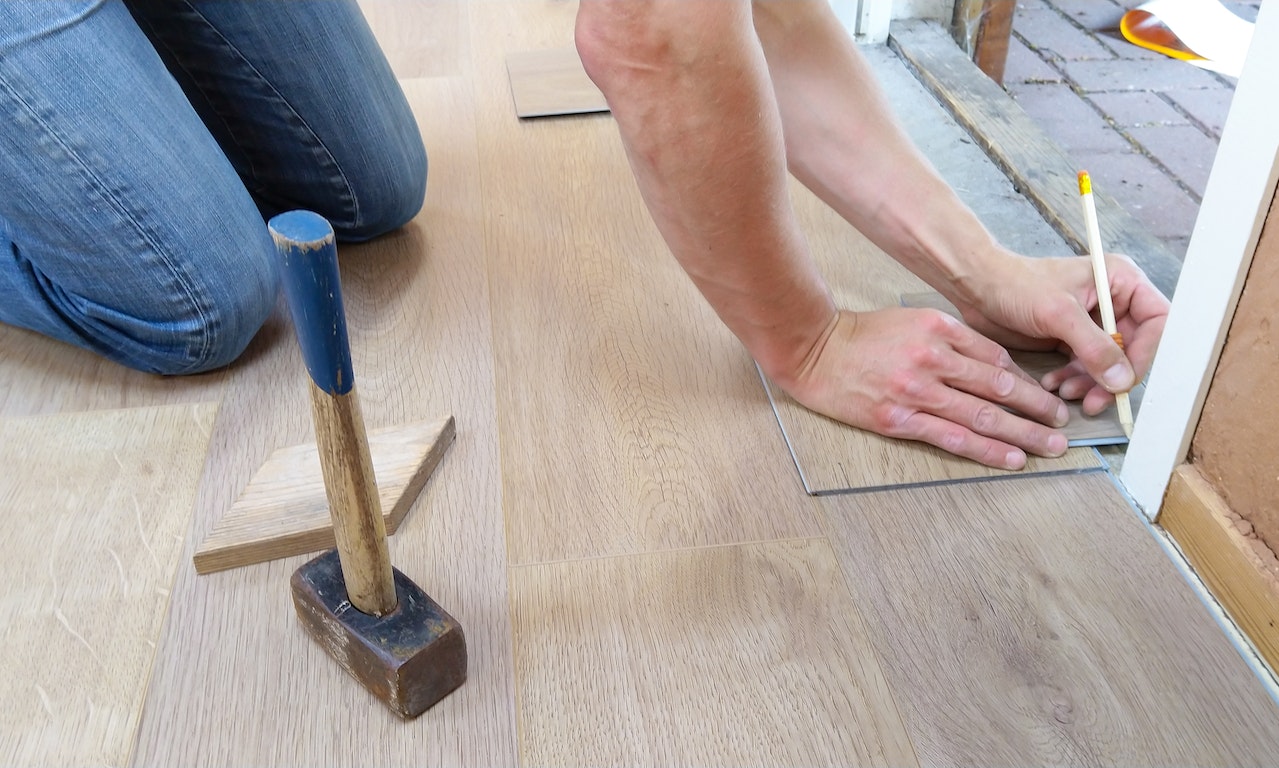 A professional installing flooring in a home.