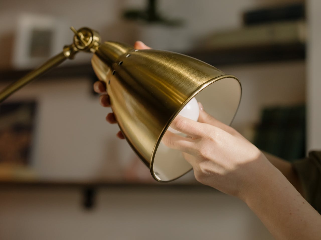 A person setting up a lamp during a basement transformation.