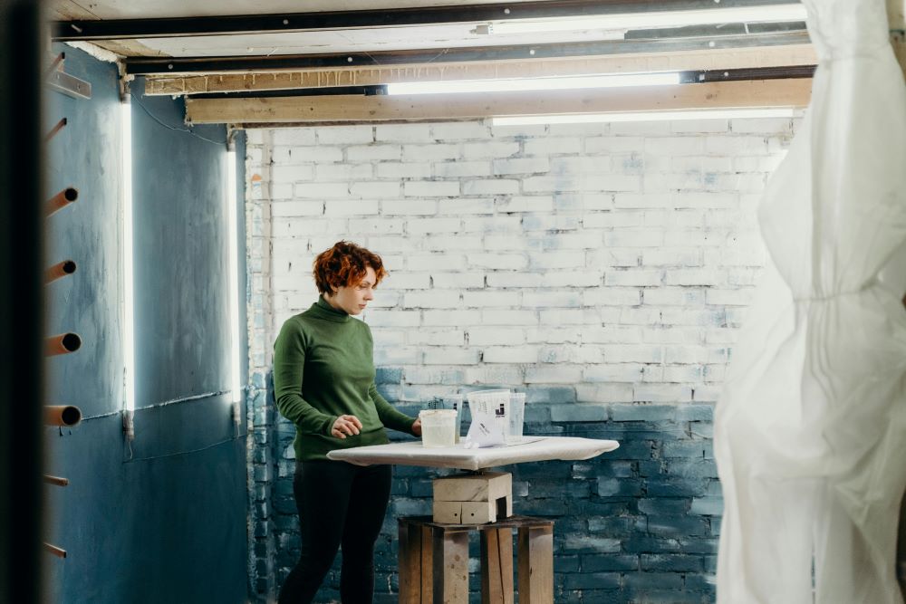 A woman painting her basement